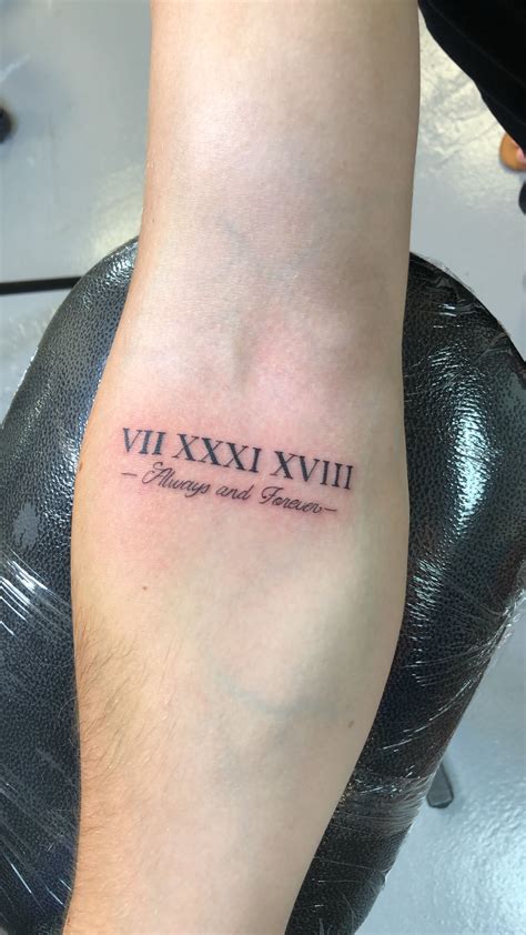 Tattoo XXIX-X-MMV Tattoo on his left shoulder. . 2005 roman numerals tattoo